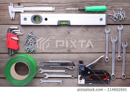 Construction tools on a grey wooden desk. 114602691