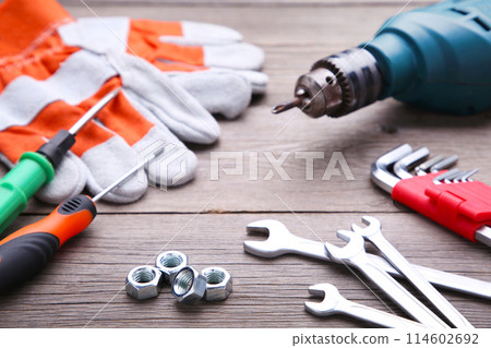 Construction tools on a grey wooden desk. Construction tools on a grey wooden desk. 114602692