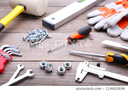 Construction tools on a grey wooden desk. 114602696