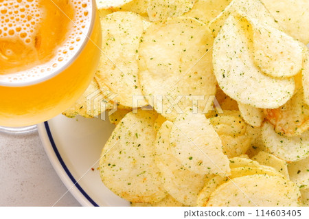 Nori salty potato chips and a glass of cold beer Nori salty potato chips and a glass of cold beer 114603405