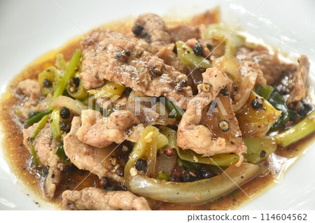 spicy stir fried slice pork meat with onion and sweet chili couple black pepper on plate spicy stir fried slice pork meat with onion and sweet chili couple black pepper on plate 114604562