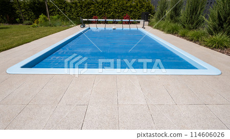 Home outdoor pool covered with film to save chemicals, water and heat preservation Home outdoor pool covered with film to save chemicals, water and heat preservation 114606026