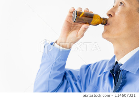 Man in work clothes Energy drink 114607321
