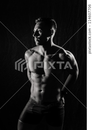 A smiling male bodybuilder. The picture is suitable for advertising sports goods and services. 114607706