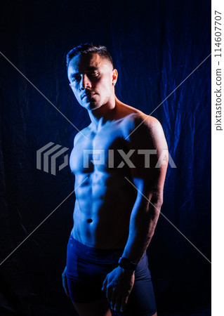 A smiling male bodybuilder. The picture is suitable for advertising sports goods and services. 114607707