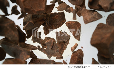 Tasty chocolate chunks falling into yoghurt cream, top down view 114608758