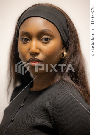 Intimate Portrait of a Young Black Woman in Elegant Attire Intimate Portrait of a Young Black Woman in Elegant Attire 114608793