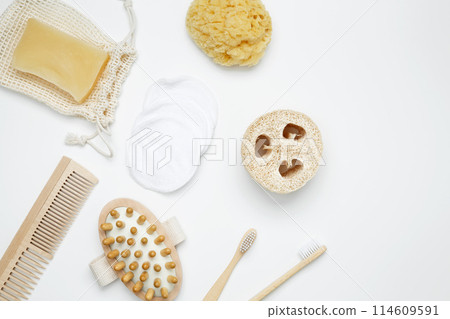 Natural organic eco cosmetics. Soap Eco, reusable cotton pads, loofah natural sponge washcloth, cotton swab, eucalyptus leaves on white background. Flat lay, top view, copy space 114609591