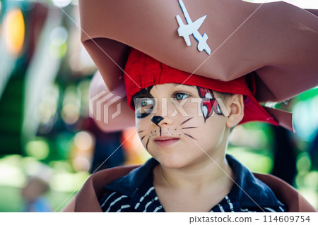 Boy Cat Pirate costume. Halloween party in kindergarten. Aqua makeup painted kids face. Bright festive Boy Cat Pirate costume. Halloween party in kindergarten. Aqua makeup painted kids face. Bright festive 114609754