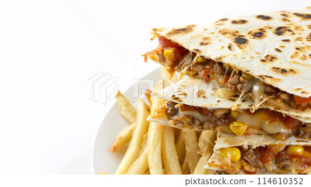 an artisan jucy quesadilla with sauce, surrounded by golden and french fries on a white background an artisan jucy quesadilla with sauce, surrounded by golden and french fries on a white background 114610352