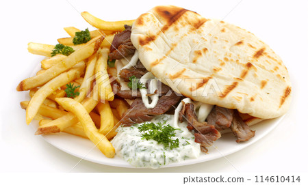 an artisan juicy gyros with sauce, surrounded by golden and french fries on a white background 114610414