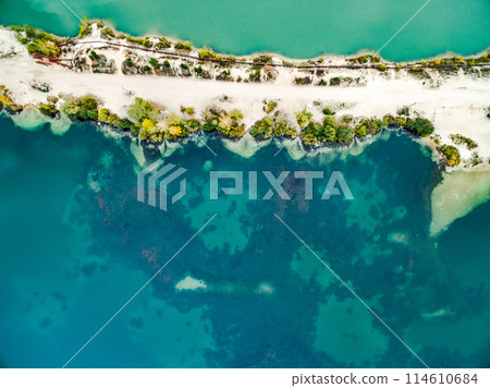 sandy shore with colourful water 114610684