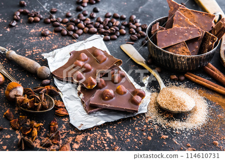 Chocolate with nuts and spices on a table 114610731