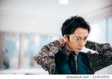 A young groom getting ready in his room 114610959