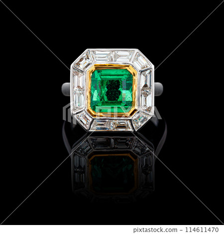 beautiful ring made of gold with precious stones emerald and diamonds on a black background 114611470