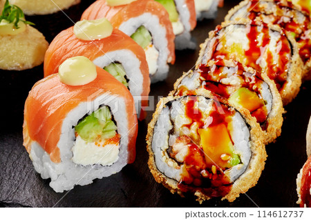 Tempura roll with unagi sauce and salmon uramaki with mayo 114612737