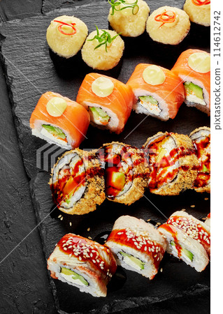 Sushi roll set with salmon, eel and cheese on slate board 114612742
