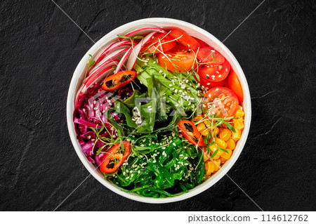Colorful vegan poke bowl with vegetables, seaweed, and sesame 114612762
