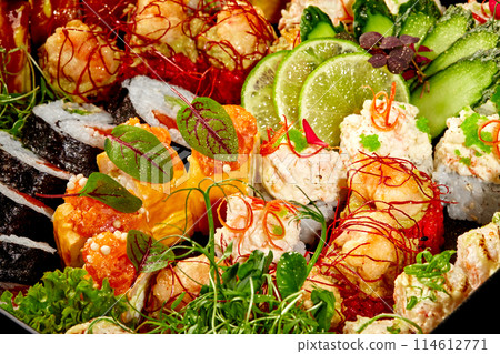 Vibrant sushi rolls platter with various toppings and fillings 114612771