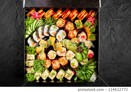 Delightful sushi roll set with fresh garnishes in black box Delightful sushi roll set with fresh garnishes in black box 114612772