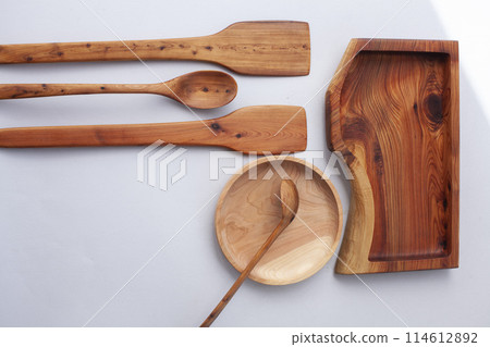 Wooden kitchen utensils stacked view, spoon and spatula close up Wooden kitchen utensils stacked view, spoon and spatula close up 114612892