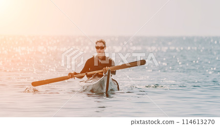 Woman sea kayak. Happy smiling woman in kayak on ocean, paddling with wooden oar. Calm sea water and horizon in background. Active lifestyle at sea. Summer vacation. Woman sea kayak. Happy smiling woman in kayak on ocean, paddling with wooden oar. Calm sea water and horizon in background. Active lifestyle at sea. Summer vacation. 114613270