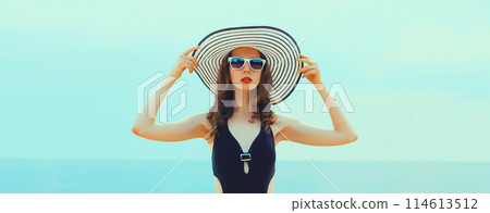 Summer vacation, beautiful young woman in bikini swimsuit and straw hat on the beach at sea 114613512