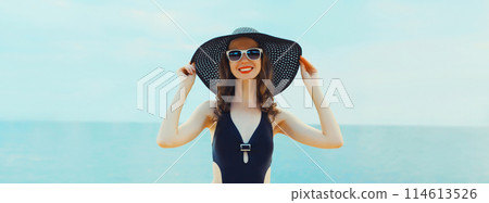 Summer vacation, beautiful happy smiling woman in bikini swimsuit and straw hat on the beach at sea 114613526