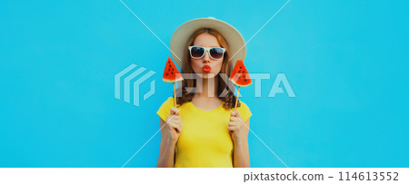 Summer portrait of stylish young woman with juicy lollipop or ice cream shaped slice of watermelon 114613552