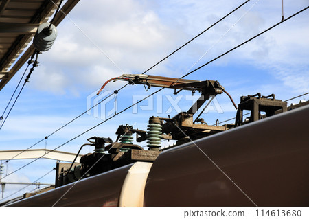 Pantograph of an electric train connecting the train to the overhead catenary wire Pantograph of an electric train connecting the train to the overhead catenary wire 114613680