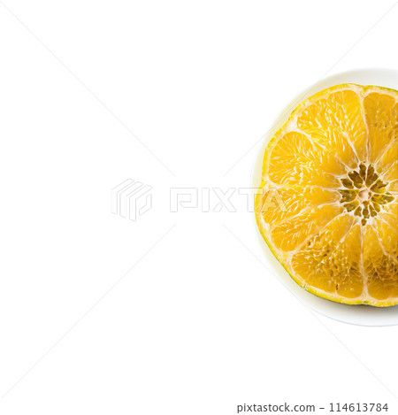 Ugli fruit large and lumpy with a mottled yellow green exterior peeled and segmented on 114613784