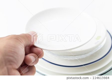 Man holding tableware on white background Man holding tableware on white background 114613984