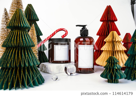 dark jar with lid and dispenser on the background of Christmas decorations, side view 114614179