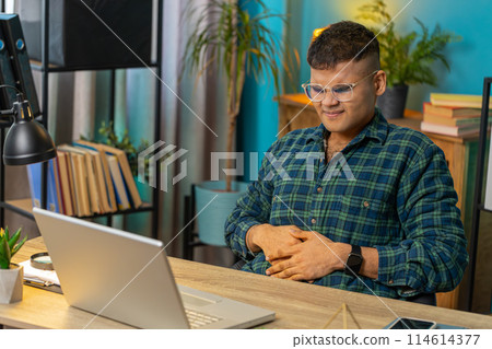 Indian man feeling sudden strong abdominal stomach ache gastritis problem diarrhea at home office 114614377