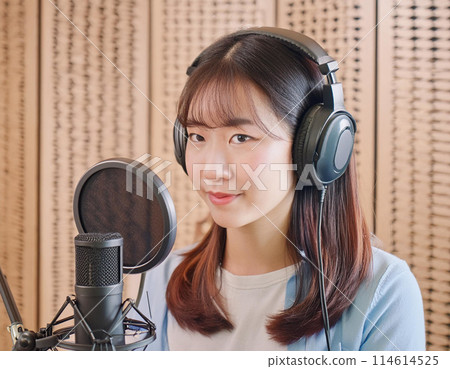 Female voice actor dubbing an animation in a recording studio 3 Female voice actor dubbing an animation in a recording studio 3 114614525