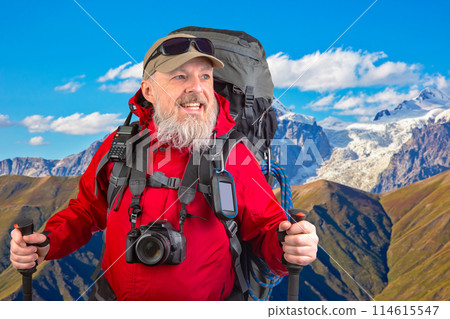 happy bearded man traveler with hiking equipment against the back happy bearded man traveler with hiking equipment against the back 114615547