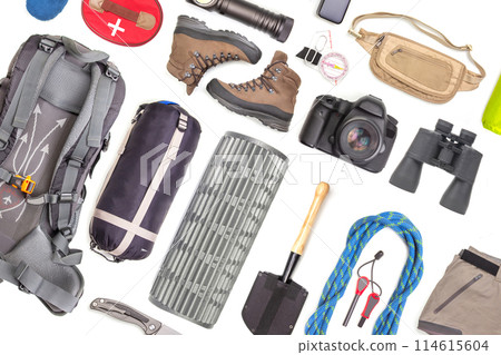 Set of tourist trekking items on white background. Top view of accessories for travel 114615604