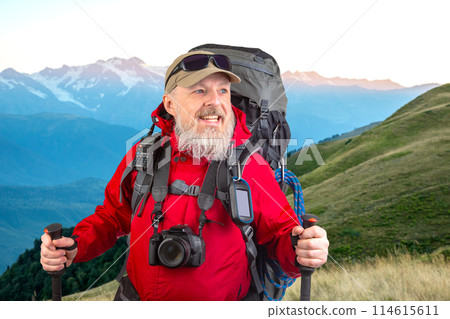 happy bearded man traveler with hiking equipment against the backdrop of a mountain happy bearded man traveler with hiking equipment against the backdrop of a mountain 114615611