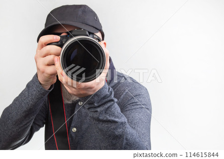 male photographer with a camera in his hands on a white background 114615844