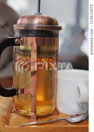 Tableware set with French press, cup, and spoon for serving tea at home Tableware set with French press, cup, and spoon for serving tea at home 114615978