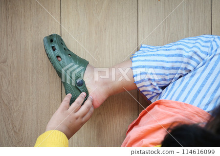 little girl feet trying to remove her sandal little girl feet trying to remove her sandal 114616099