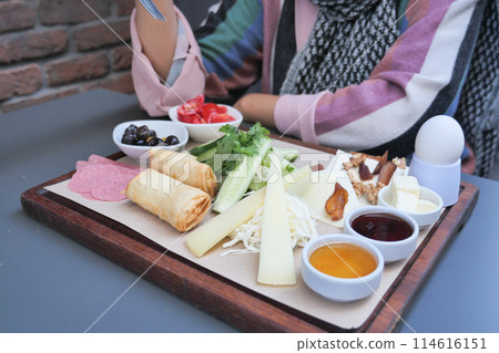 woman eating Turkish Breakfast Served on Table  114616151