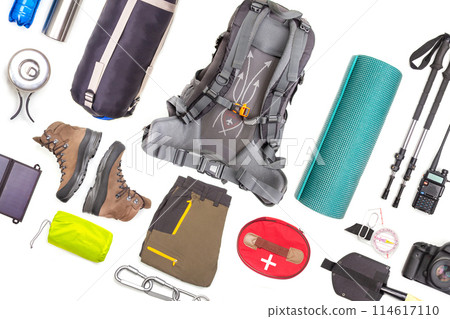 Set of tourist trekking items on white background. Top view of accessories for travel Set of tourist trekking items on white background. Top view of accessories for travel 114617110