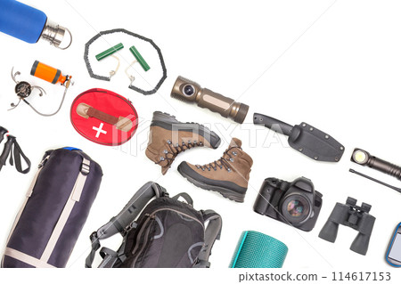 Set of tourist trekking items on white background. Top view of accessories for travel Set of tourist trekking items on white background. Top view of accessories for travel 114617153