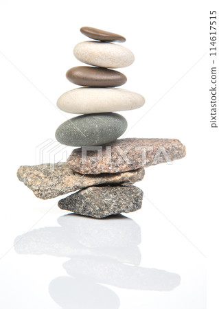 pyramid of stacked stones on a white background. stabilization and balance in life 114617515