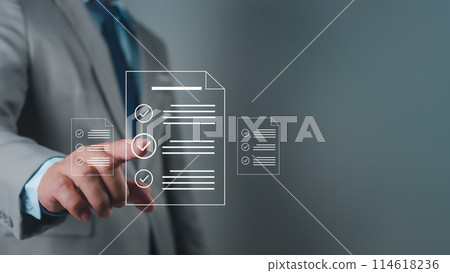 Businessman using hands to check and fill out online survey form DMS document management system, quality control and verification 114618236