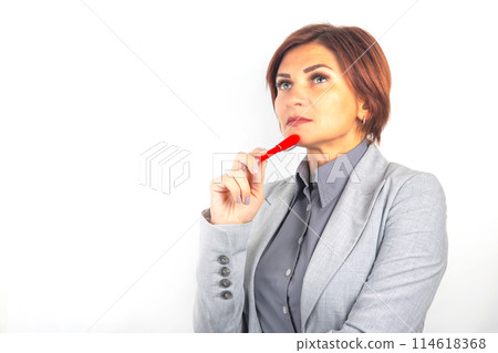 Beautiful young business woman in a suit thinks over her project on a white background Beautiful young business woman in a suit thinks over her project on a white background 114618368