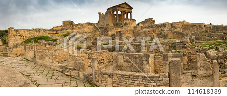 Ruins of ancient Roman capitol on territory of antic city of Dougga in area of modern Tunisia. Ruins of ancient Roman capitol on territory of antic city of Dougga in area of modern Tunisia. 114618389