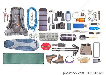 Set of tourist trekking items on white background. Top view of accessories for travel Set of tourist trekking items on white background. Top view of accessories for travel 114618426