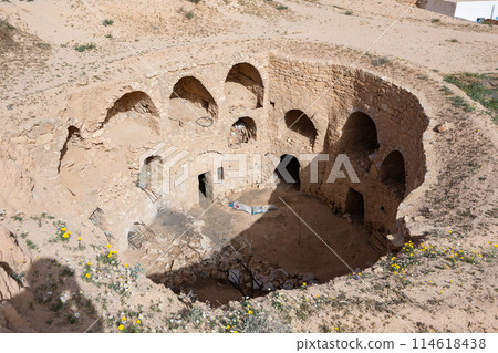 Ancient Berber dwellings carved into walls of earthen pit in Matmata Ancient Berber dwellings carved into walls of earthen pit in Matmata 114618438